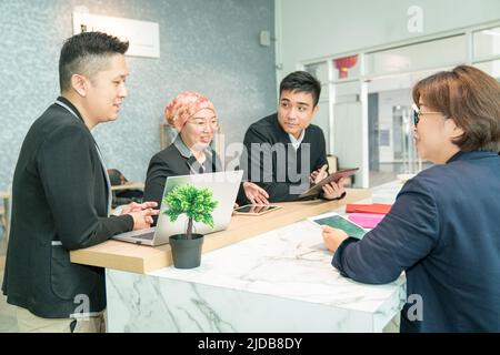 Business work colleagues having a meeting in a co working share space. Stock Photo