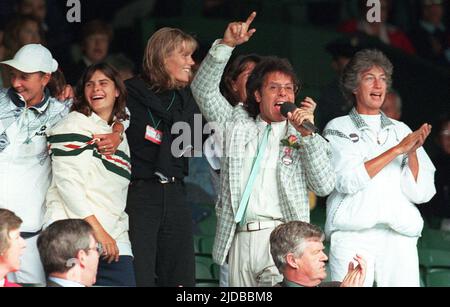 File photo dated 03-07-1996 of Sir Cliff Richard singing on Centre Court at Wimbledon after rain stopped play. What more British way to put up with a rain break at Wimbledon than a singalong led by tennis fan Sir Cliff Richard? That is exactly what happened in 1996, with tennis stars including Wade as backing singers. Issue date: Monday June 20, 2022. Stock Photo