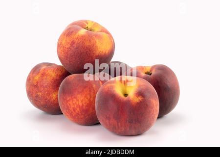 Peaches isolated on bright background. Close up view. Stock Photo