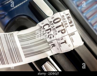 A suitcase with an airline baggage tag shows the three letter airport code for OTP, Bucharest airport and CDG, Paris airport Stock Photo