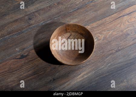 Wooden laminate parquet floor with texture and bamboo wooden empty bowl. High quality photo Stock Photo