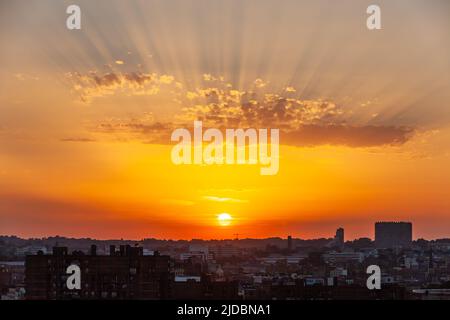 Sunset over the city, sun rays through clouds. Brussels Stock Photo
