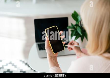 Woman using digital gadget smartphone device pc for online shopping video conference call. Distance learning online education home office and work Stock Photo