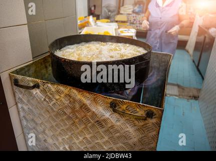 Bari, Puglia, Italy. August 2021. In the historic center, the old bari, street food: slices of polenta fried in boiling oil, specialties called sgagli Stock Photo