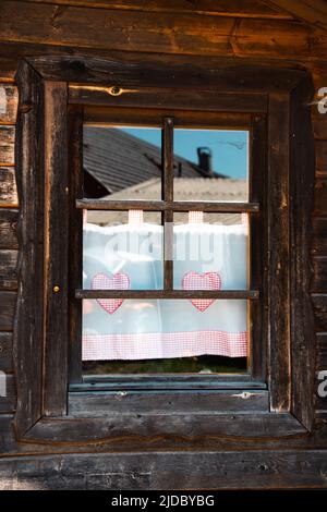 Rustic wooden cabin window in the German Alps Stock Photo