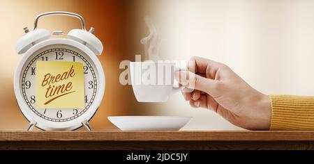 Alarm clock with sticky note and woman having a coffee break Stock Photo