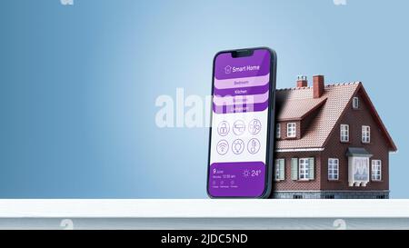 Smart home control app on smartphone and model house, home automation concept, blank copy space Stock Photo