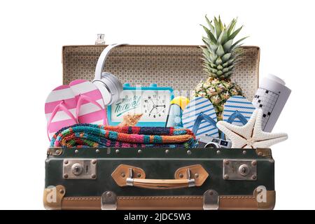 Open vintage suitcase with beach accessories, summer vacations concept Isolated on white background Stock Photo