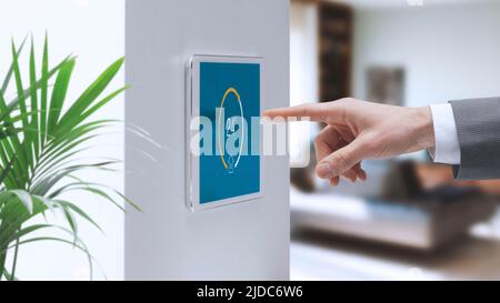 Man setting home interior temperature on the smart home system control panel, home automation concept Stock Photo