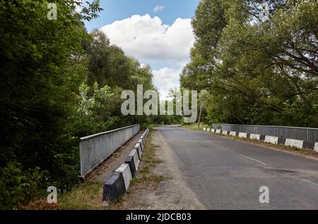 Barrier, designed to prevent the exit of the vehicle from the curb or bridge. Guarding rail on suburban road Stock Photo