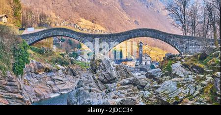 The view through the arch of the Salt Bridge (Ponte degli Salti) on the medieval church of Santa Maria degli Angeli, Lavertezzo, Valle Verzasca, Switz Stock Photo