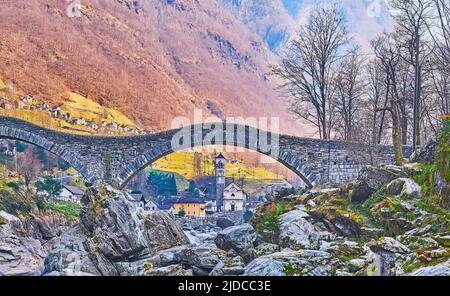 The medieval Santa Maria degli Angeli Church in arch of old Salt Bridge, Lavertezzo, Valle Verzasca, Switzerland Stock Photo