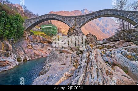 Enjoy the scenic rocky landscape of Valle Verzasca and preserved stone double-arched Ponte dei Salti (Salt Bridge), Lavertezzo, Switzerland Stock Photo