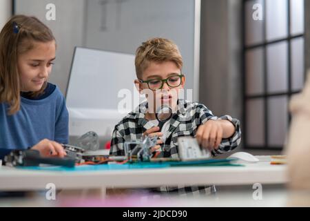 Pupils at school working with electronics component at robotics classroom. Stock Photo
