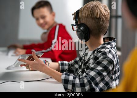Schoolboy using computer in classroom at school Stock Photo