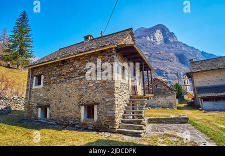 The old small stone house with stone coated roof and stairs made of stone tiles, Sonogno, Valle Verzasca, Switzerland Stock Photo