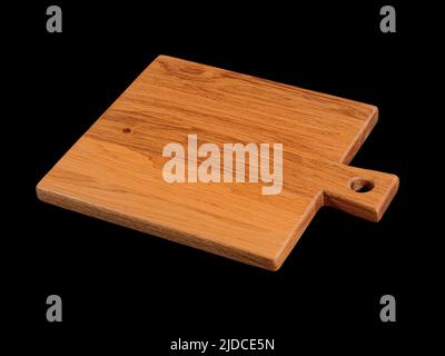 Empty brown oak wood cutting board isolated on black Stock Photo