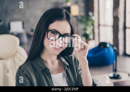 Photo of young cheerful lovely woman hand touch eyeglasses support website testing designer leader indoors Stock Photo