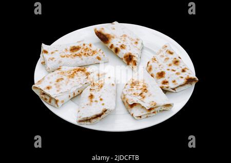 Fresh roll of lavash, pita bread, chicken, Shawarma sandwich gyro lamb or beef shawarma Traditional Eastern snack. Stock Photo