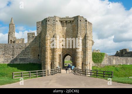 Father son, rear view of a father taking his son to visit a medieval castle on a sunny day, Northumberland, England, UK Stock Photo