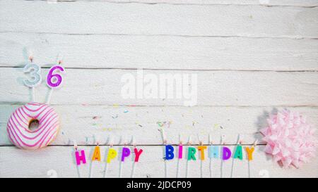 Happy birthday card with number. Pink donuts with decorations for happy birthday greetings from candles. Birthday card copy space Stock Photo