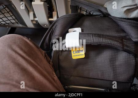 Cabin bag in front of seet on economy class flight Stock Photo