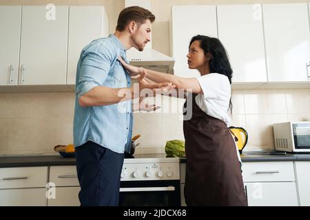 Woman and man having quarrel in kitchen Stock Photo