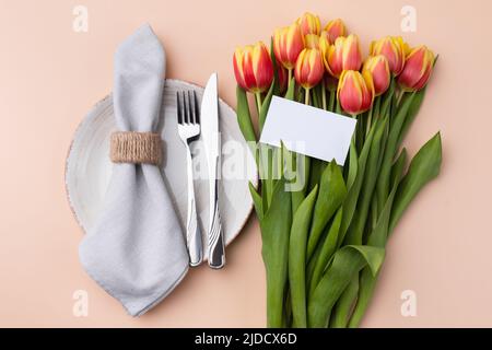 Festive Table Setting With Tulips. Holiday Table Set for Birthday, Mother's Day or for another holiday. Stock Photo