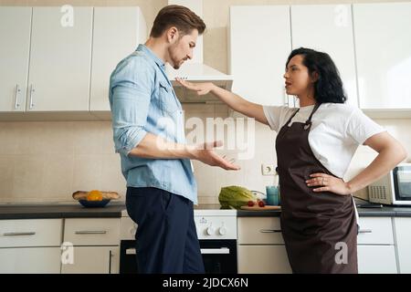 Unhappy family couple having quarrel at home Stock Photo