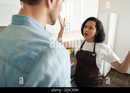 Irritated young female having altercation with man Stock Photo