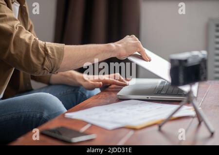 Male hands opening laptop on table Stock Photo