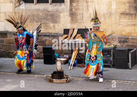 Charango, traditional Peruvian music, being played on pan flutes by Peru Indians in bright elaborate costumes Stock Photo