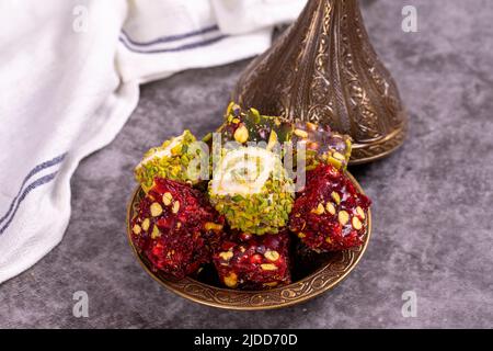 Turkish delight on a dark background. Traditional Turkish delicacies. Varieties of Turkish Delight with Pistachio. close up Stock Photo
