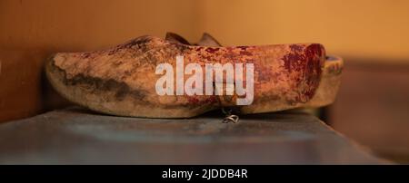 Enkhuizen, Netherlands, June 2022. Old wooden shoes on a bench. High quality photo. Selective focus. Stock Photo