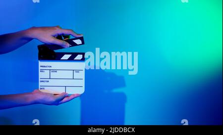 Movie Clapper board. Crew hand holding plastic and wooden film slate board against camera. Movie clapperboard using in video production and movie stud Stock Photo