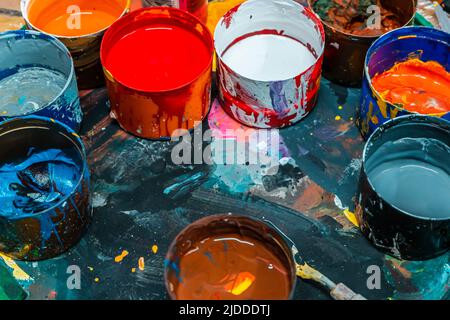 Jars of bright colors in an art workshop Stock Photo