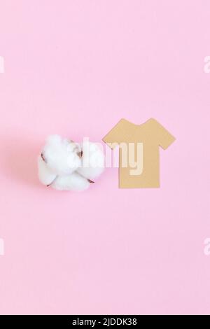 Cotton plant and paper t-shirt mockup on pink background. Stock Photo