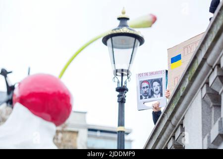 Placards are held as people gather during a Stand With Ukraine protest against Russia’s recent invasion of Ukraine at Trafalgar Square in London. Stock Photo