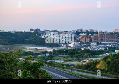 Sunrise over sprawling apartments and neighborhoods along urban - rural divide Stock Photo