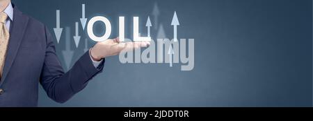 Oil trend. Energy crisis with stock market. current change in price of barrel of oil. usinessman showing word oil and arrow up and down. wide blue ban Stock Photo