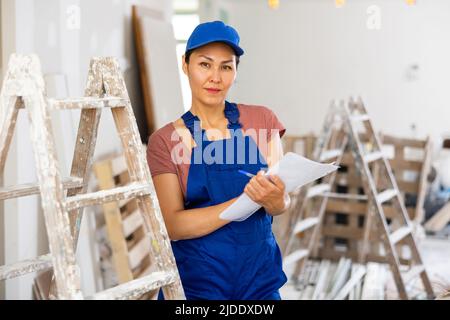Woman construction worker with project documentation Stock Photo