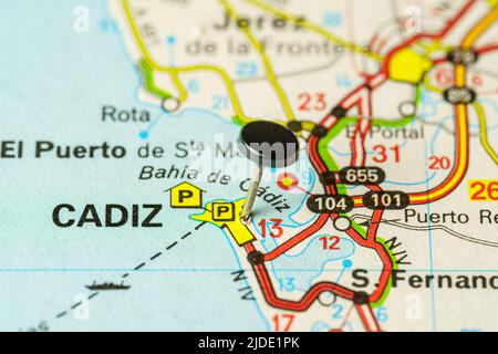 Tourist destination of Cadiz with a pin on a map, macro photo.