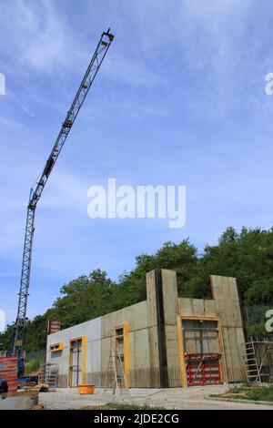 Construction crane swings over a shell Stock Photo