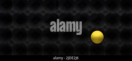 Yellow egg ball inside Pyramid Acoustic Foam Tile Black Texture. Concept of being different and loneliness. Stock Photo