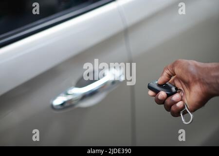 Close-up image of car owner using electronic key to open or lock door Stock Photo