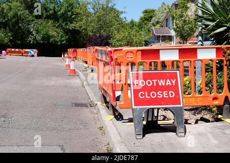 UK housing estate footpaths are closed and dug up whilst work goes ahead to update the estates homes to ultra fast broadband and digital phone lines Stock Photo