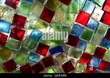 Colorful square glass mosaic stones glued on a glass plate. Meant as background Stock Photo