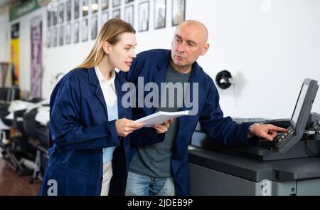 Man and woman working in printshop Stock Photo
