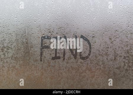 Handwritten lettering find on misted glass on window with raindrops, concept of full life and motivation Stock Photo