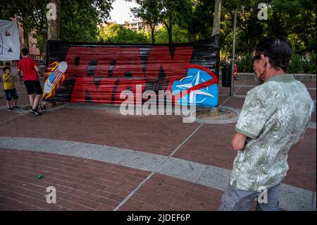 Madrid, Spain. 19th June, 2022. A banner with the words No to NATO is seen during a protest in Vallecas neighborhood of Madrid. Spain will host a NATO Summit in Madrid on 28, 29 and 30 June 2022. Credit: Marcos del Mazo/Alamy Live News Stock Photo